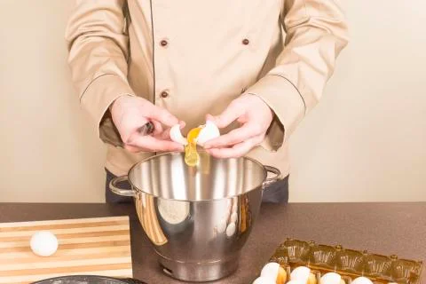 Cook egg retrieves from the shell of Stock Photos