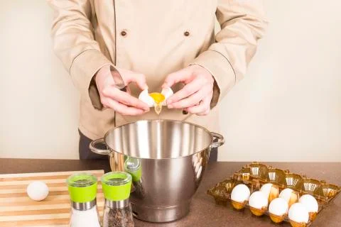 Cook egg retrieves from the shell of Stock Photos