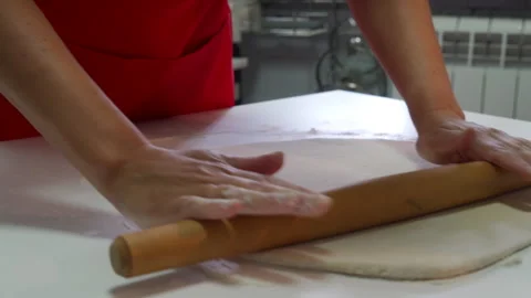 Cook Energetically Rolls Flat Dough With Pin For Homemade Pastry Stock Footage 321639603