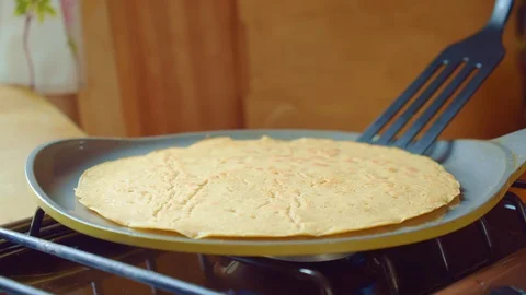 Cook flips delicious bake flapjack with spatula in frying pan. Close up. Slowmo. Stock Footage 127967132