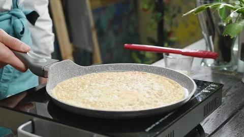 The cook flips pancake in the frying pan. Stock Footage 246860952