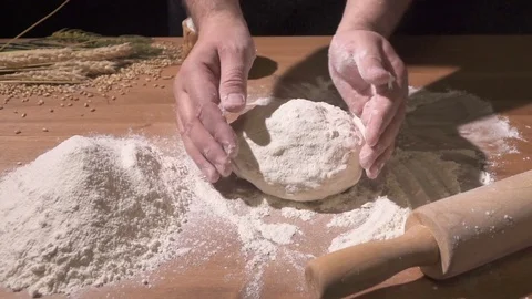 The cook forms the dough by hand and places it on the table Stock Footage 76399848