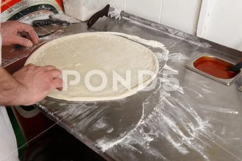 Cook forms a dough pizza base Stock Photos