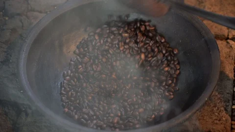 Cook fried coffee beans on open fire in tourist cafe, Bali, Indonesia, close up Stock Footage 108832421