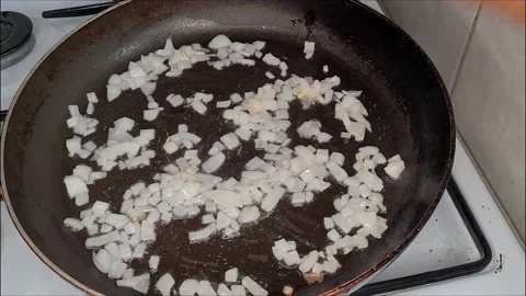 Cook Fried Onions In A Pan  Stock Footage 165542842
