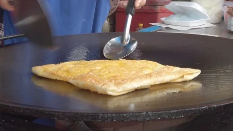 Cook fried pancake in hot pot. Delicious street food dessert Stock Footage 112160176