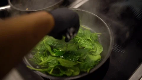 Cook fries leaf spinach in pan slow motion Video stock 108109745