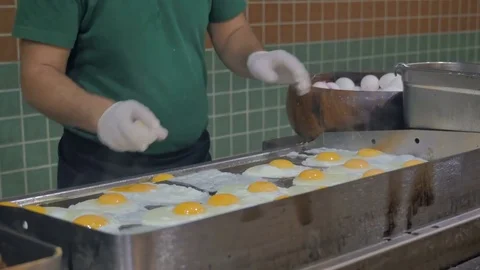 The cook fry eggs for breakfast. Buffet in the restaurant, in the hotel Stock Footage 80637929