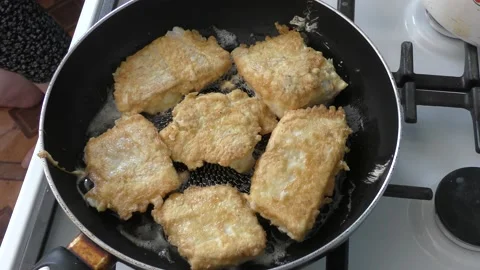 The cook fry the fish in a pan Stock Footage 166702528