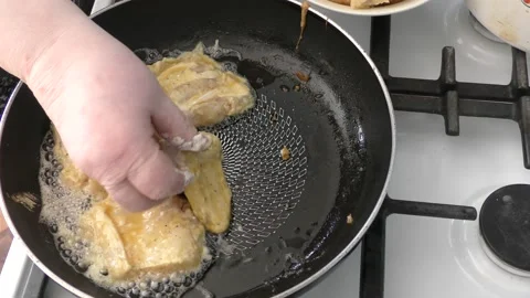 The cook fry the fish in a pan Stock Footage 166704251