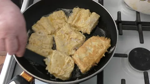 The cook fry the fish in a pan Stock Footage 166704624