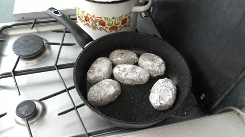 Cook frying cutlets in a pan for dinner Stock Footage 136632118