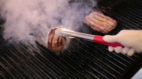 Cook frying the meat on the grill Stock Footage 67862730