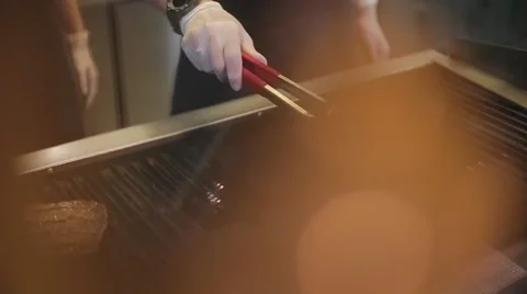 Cook frying the meat on the grill Stock Footage 67862758
