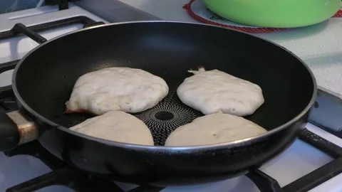 The cook is frying pancakes Stock Footage 148948037