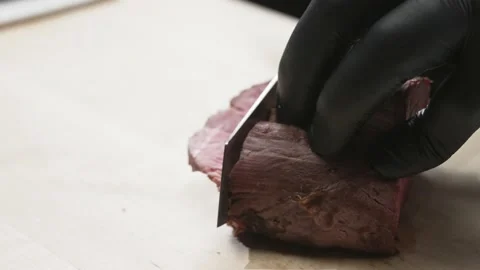A cook with gloves cuts meat Stock Footage 170396053