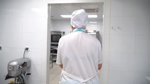 The cook goes to the kitchen to the oven Stock Footage 85661852