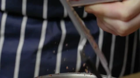 Cook grates lots of chocolate in slow motion Stock Footage 166863286