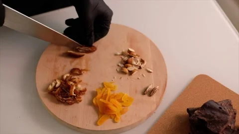 The cook grinds the dried figs Stock Footage 157277546