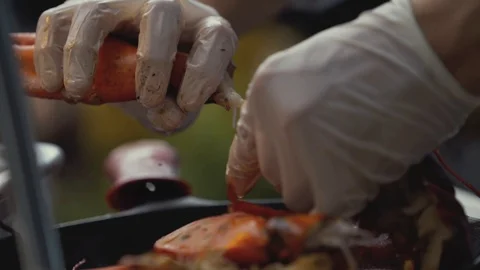 Cook hand cracking king crab legs. Chef preparing lobster in garden Stock Footage 105574212