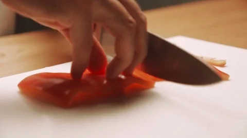 Cook hands cut into red peppers on a cutting board. The concept of a healthy Stock Footage 73274482
