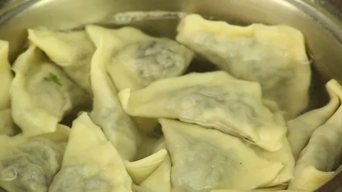 Cook hands take out the sieve ready dumplings from the pan with boiling water Stock Footage 72771073