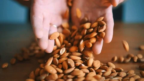 Cook hands touching almond nuts. Checks the quality of drying, color and aroma Stock Footage 114739536