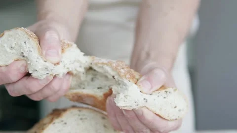 The cook has prepared the bread and is tearing it with his hands. Stock Footage 300179944