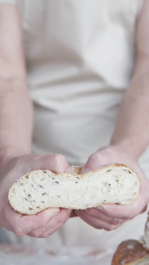 The cook has prepared the bread and tears it into two parts with his hands. Stock Footage 300879205