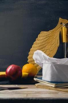 Cook hat,Chef's hat on a table with fruit carved board and dark background of Stock Photos