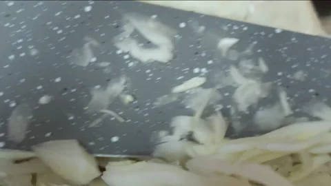 A cook in a home kitchen cuts cabbage with a knife on a cutting board. Clos.. Stock Footage 257662291