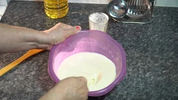 The cook interferes with the dough for making pancakes Stock Footage 85951855