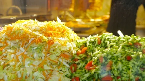 The cook keeps the plate on the background of salad, street food Stock Footage 83324333