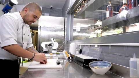 Cook at the kitchen preparing beef meat for grill Stock Footage 95887492