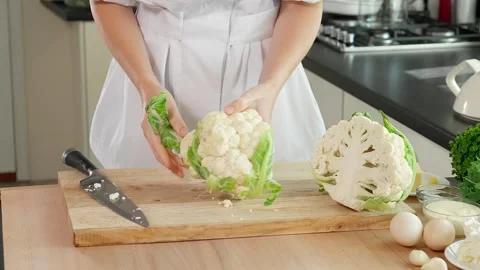 Cook in the kitchen preparing cauliflower Stock Footage 262782279