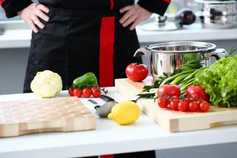 The cook in the kitchen is preparing Stock Photos