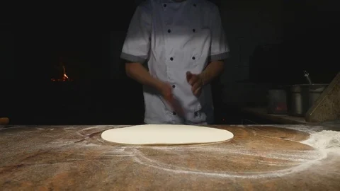 Cook in the kitchen putting the ingredients on the pizza. Pizza concept Stock Footage