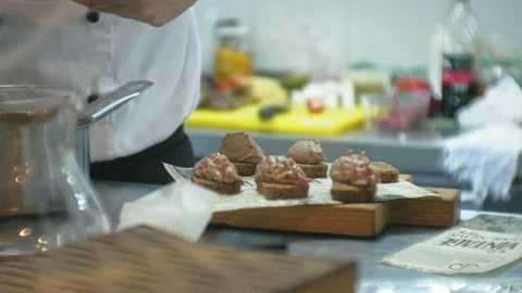 The cook in the kitchen of the restaurant prepares meat snacks Stock Footage 103492117