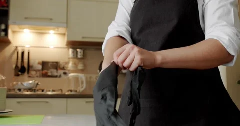 The cook in the kitchen uses black gloves. Close up Stock Footage 140473363