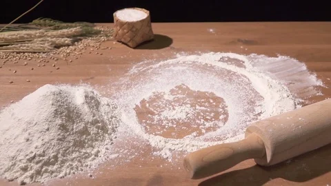 The cook kneads the dough with both hands on the flour-poured table Stock Footage 76399078