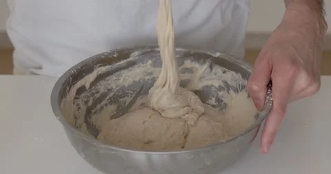 The cook kneads the dough into bread. Making bread at home. Bread baking. Bread Stock Footage 235542342