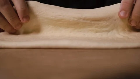The cook kneads the dough on the table in pizza flour Stock Footage 124274891