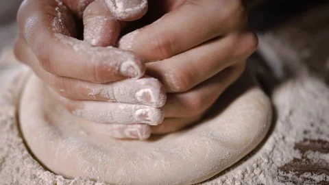The cook kneads the dough on the table in pizza flour Stock Footage 124275709