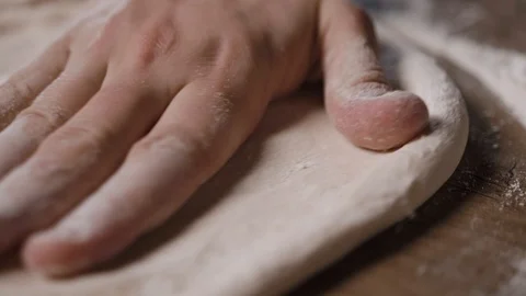 The cook kneads the dough on the table in pizza flour Stock Footage 124275803