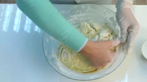The cook kneads raw dough. Video stock 86124133