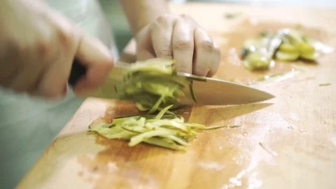 Cook a large knife on the board chopped salted canned cucumbers Stock Footage 71320907