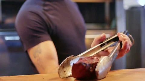 The cook is laying on the table a piece of delicious meat Stock Footage 78743239