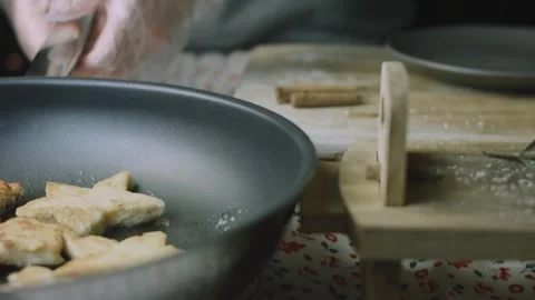 Cook lifting the skillet beside an empty serving plate Stock Footage 342127493