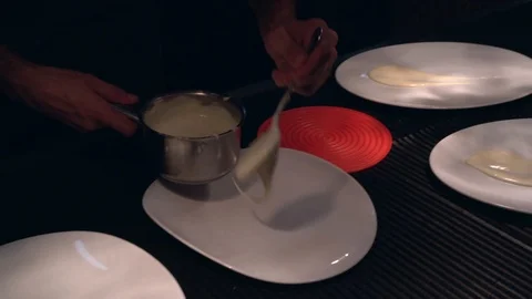 Cook  little pan while adding sauce in plate on restaurant kitchen Stock-Footage 114610367