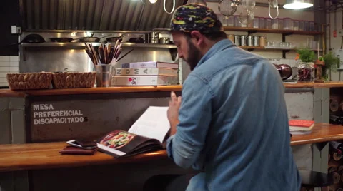 Cook looking over recipes in kitchen Stock Footage 68292881